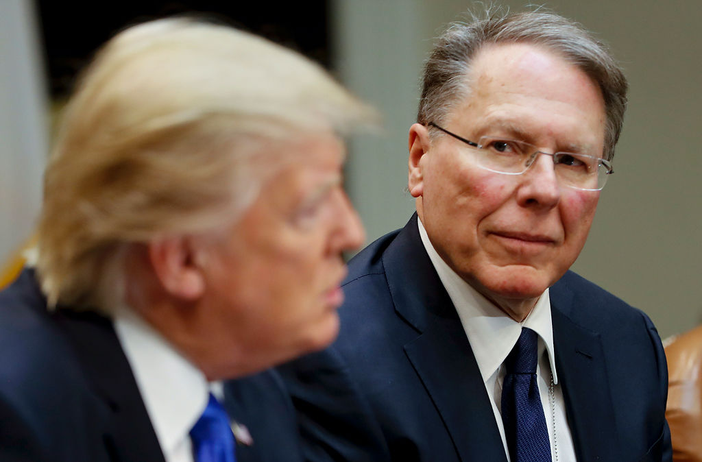 The National Rifle Association's Executive Vice President and Chief Executive Officer Wayne LaPierre listens at right as President Donald Trump speaks in the Roosevelt Room of the White House